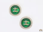 Round green stud earrings with twin C motifs lined with cz