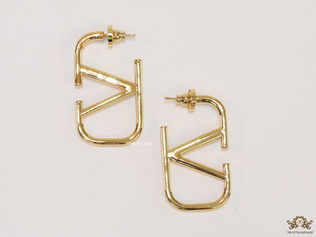 Designer golden earrings with alphabet motif