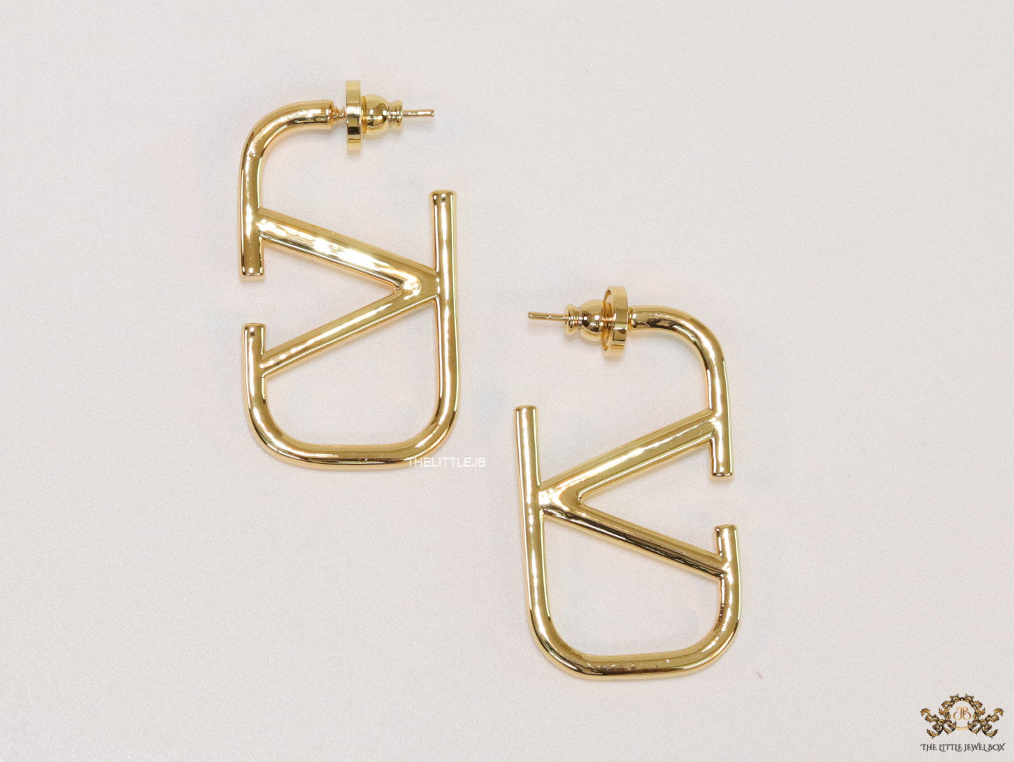 Designer golden earrings with alphabet motif