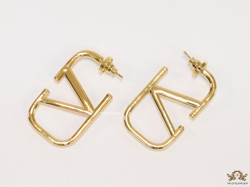 Designer golden earrings with alphabet motif