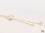 Sleek gold plated chain with different sized shell pearls.