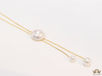 Sleek gold plated chain with different sized shell pearls.