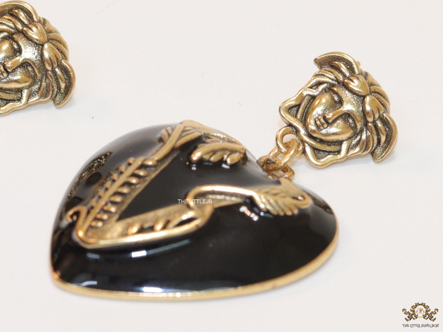 Gold plated medusa earrings with V motif black heart shape drop
