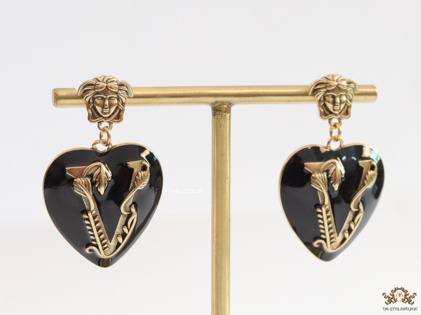 Gold plated medusa earrings with V motif black heart shape drop