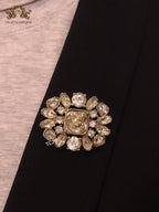 Double G brooch with uncut stones