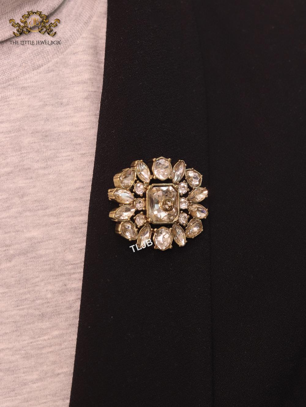 Double G brooch with uncut stones