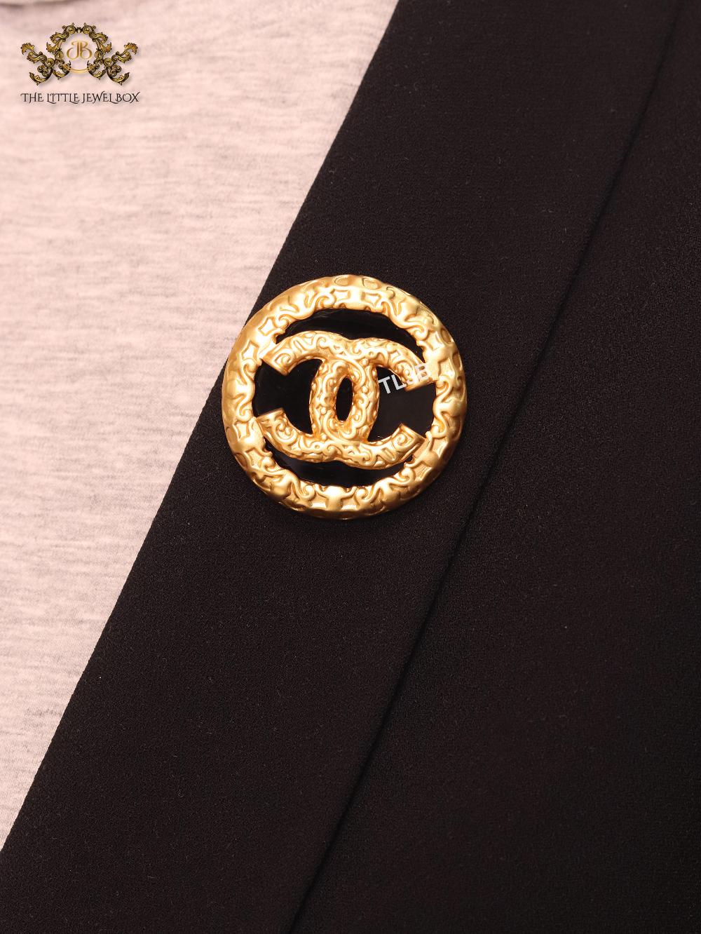 Double C gold foil and black enamel brooch