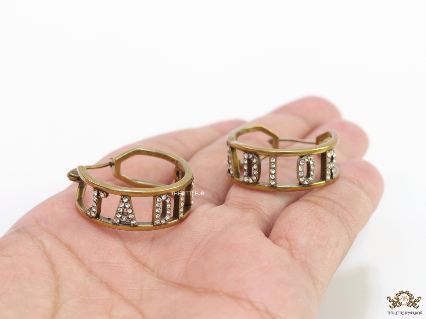 Broad golden hoops with cz alphabets