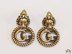 Lion head twin G earrings in gold finish