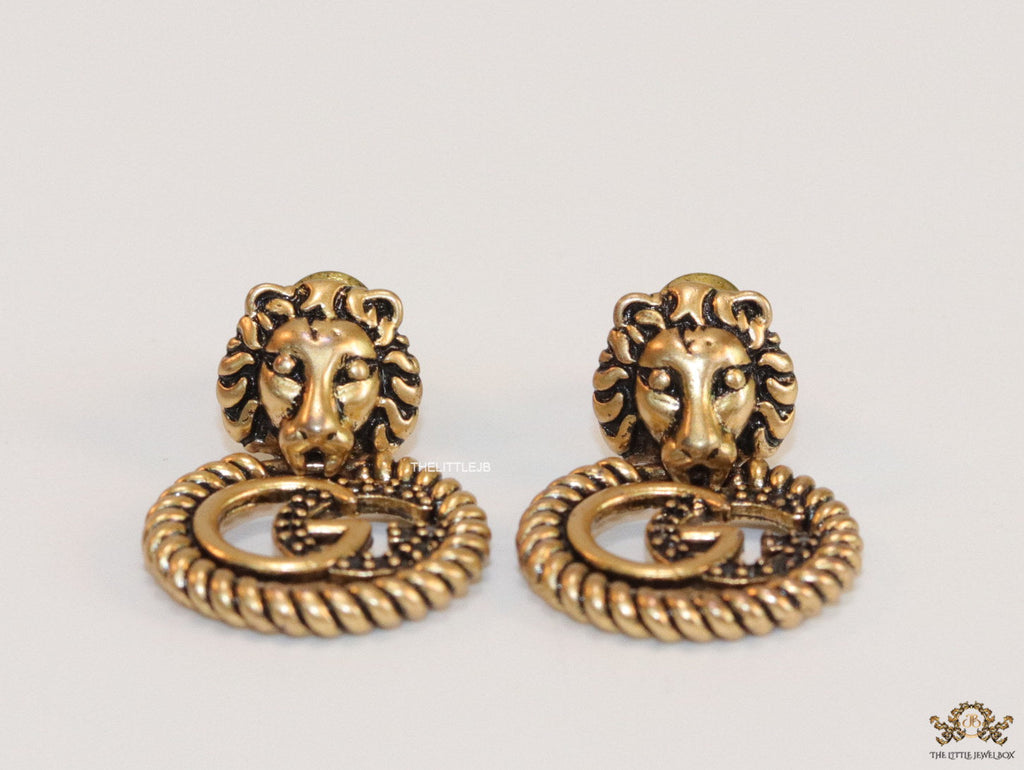Lion head twin G earrings in gold finish