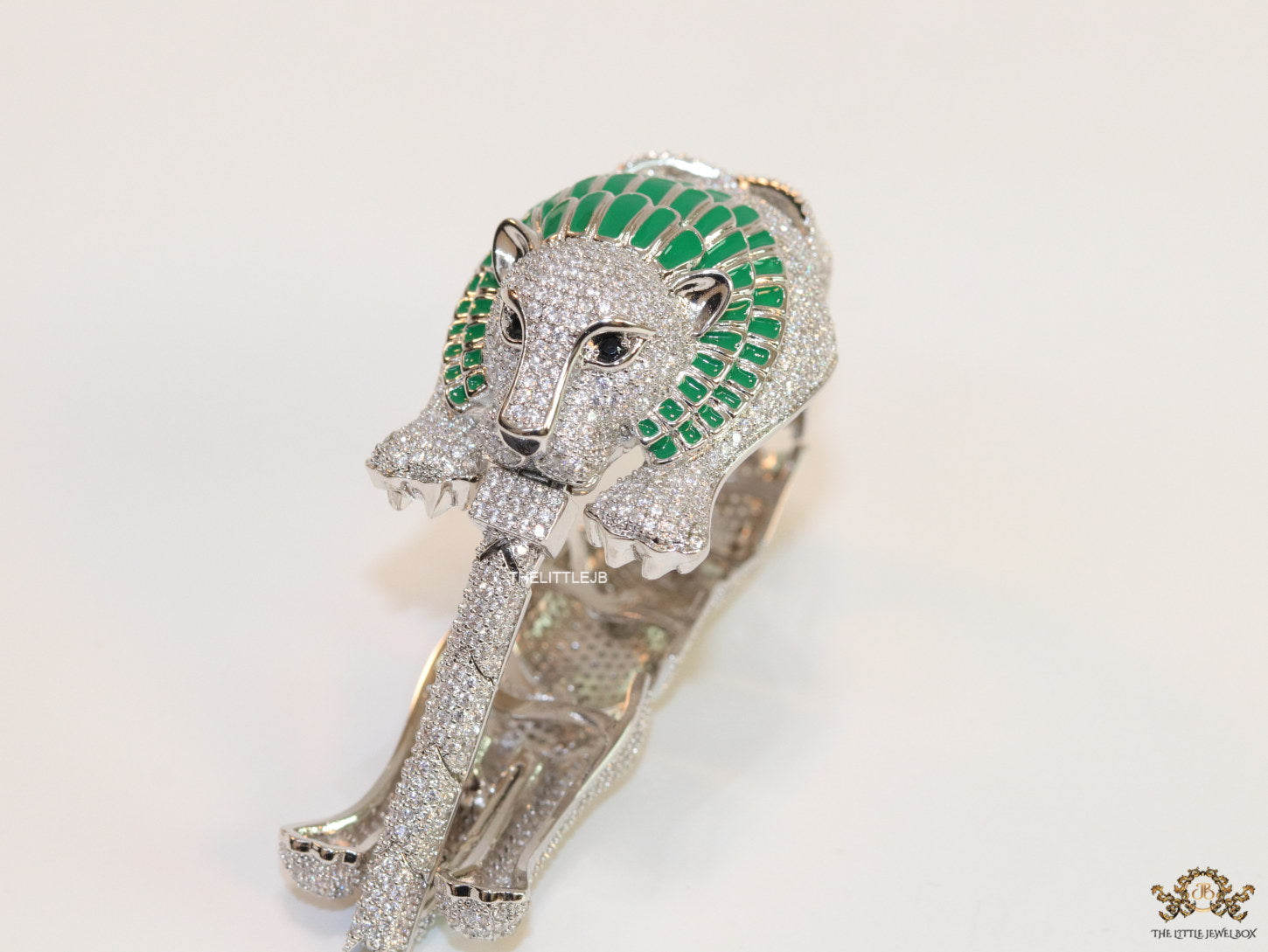 Platinum plated unique panther bracelet with cz and emerald green stones