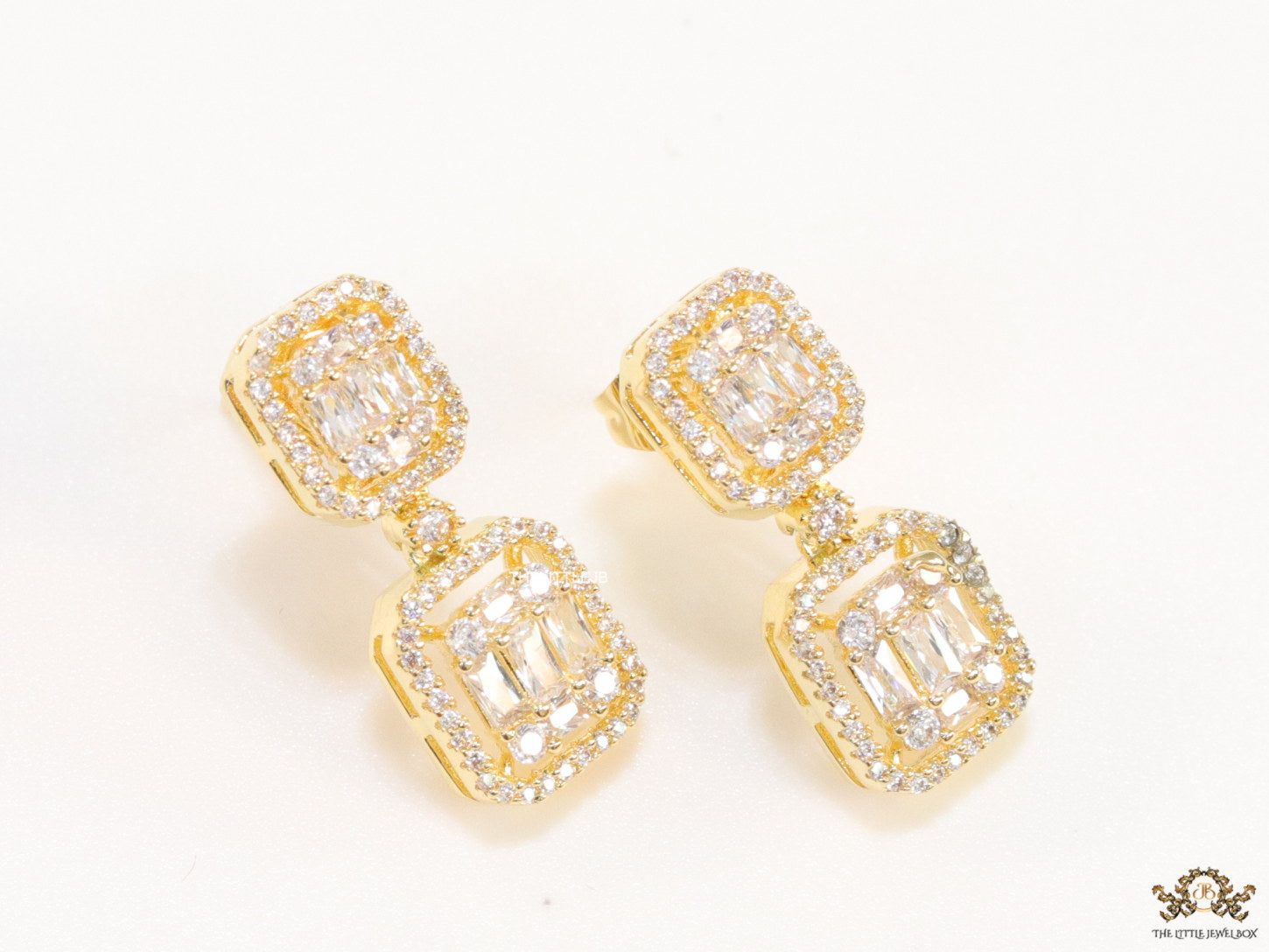 Gold plated cz dangle earrings with cz baguettes