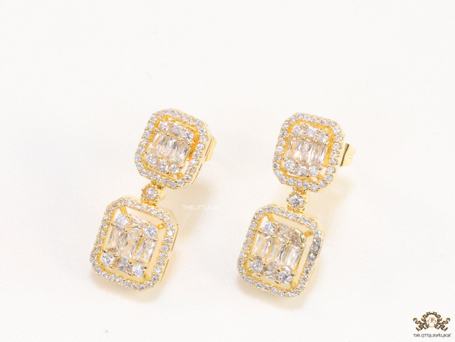Gold plated cz dangle earrings with cz baguettes