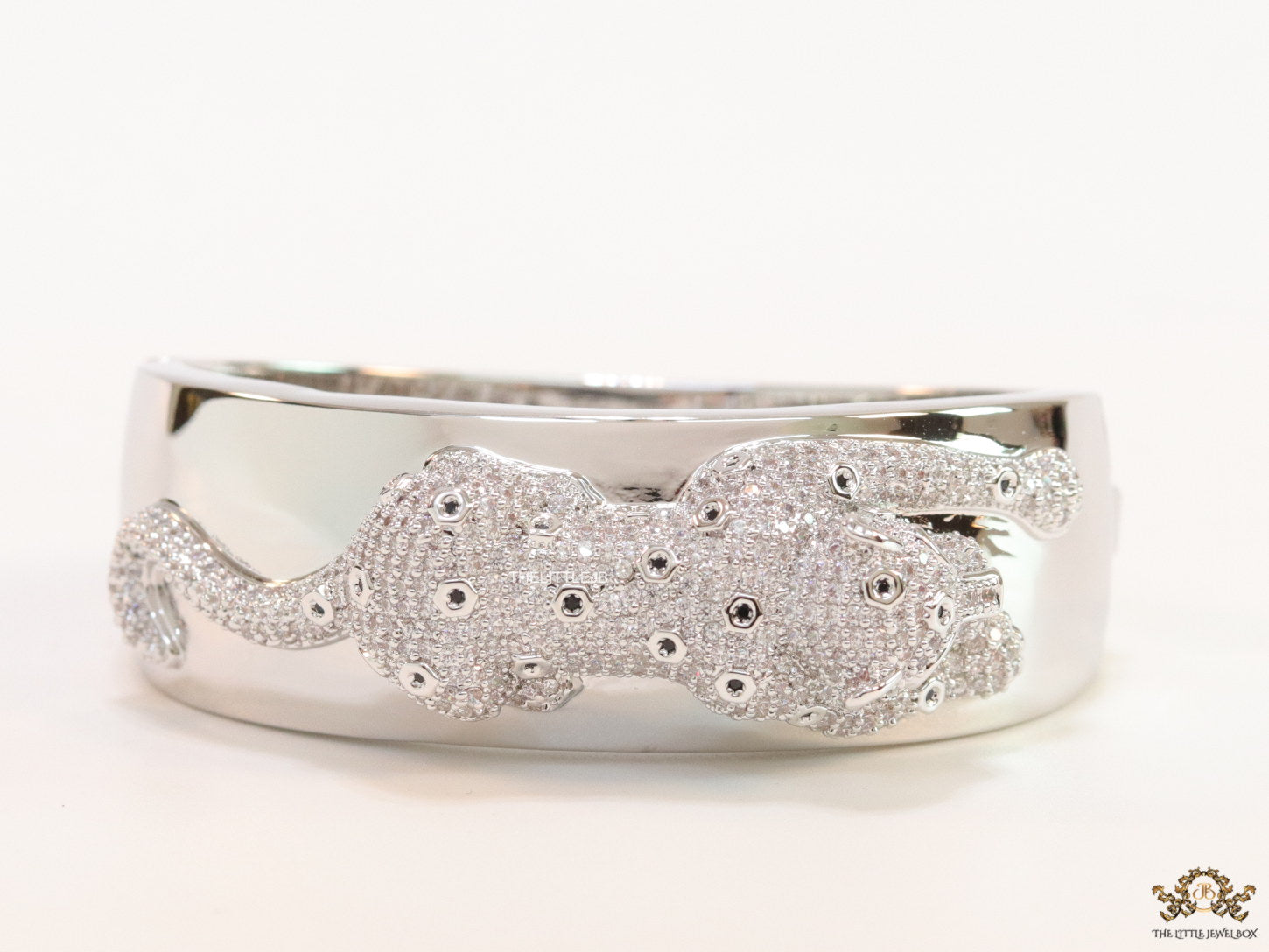 Broad band platinum bracelet with cz panther motif