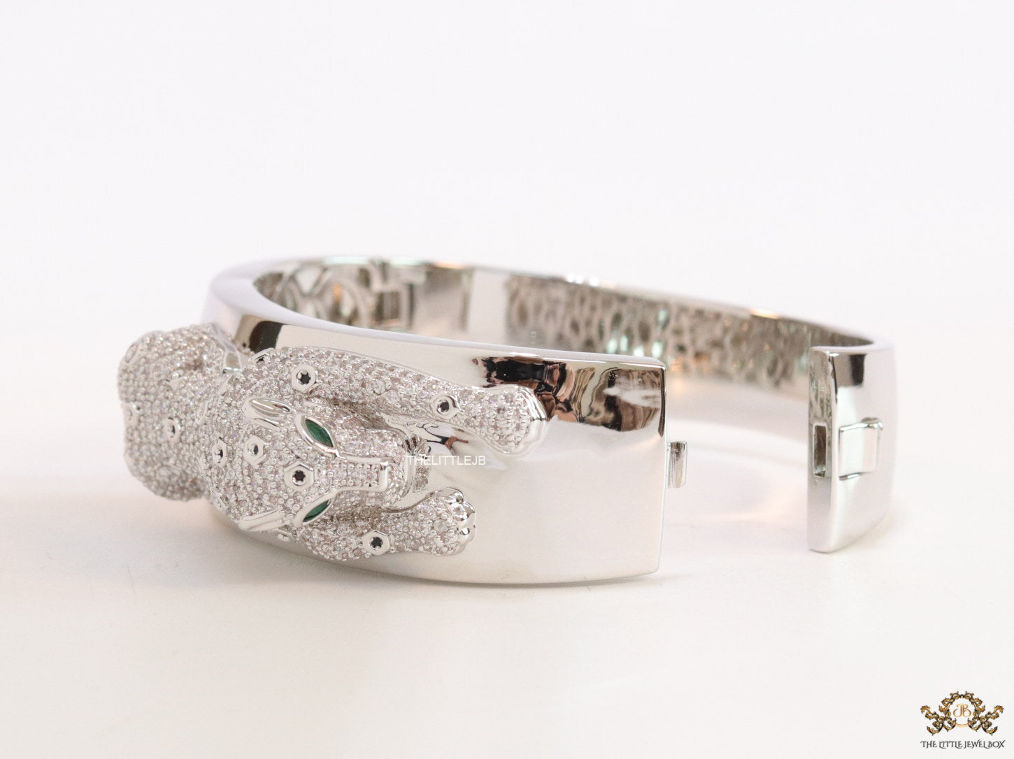 Broad band platinum bracelet with cz panther motif