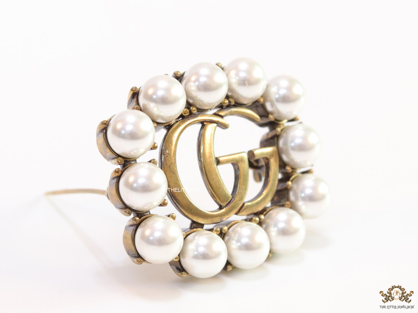 Pearls embraced alphabet brooch in gold finish