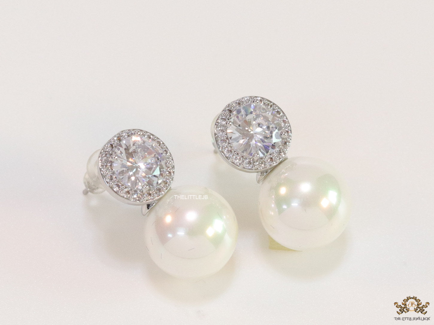 Platinum plated round cz earrings with pearl drop