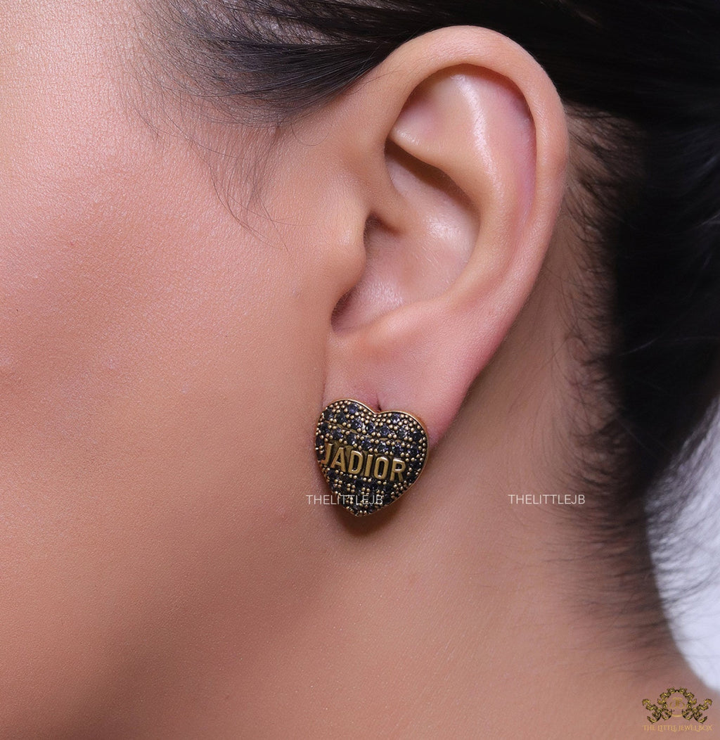 Heart shaped alphabet stud earrings in golden and black finish