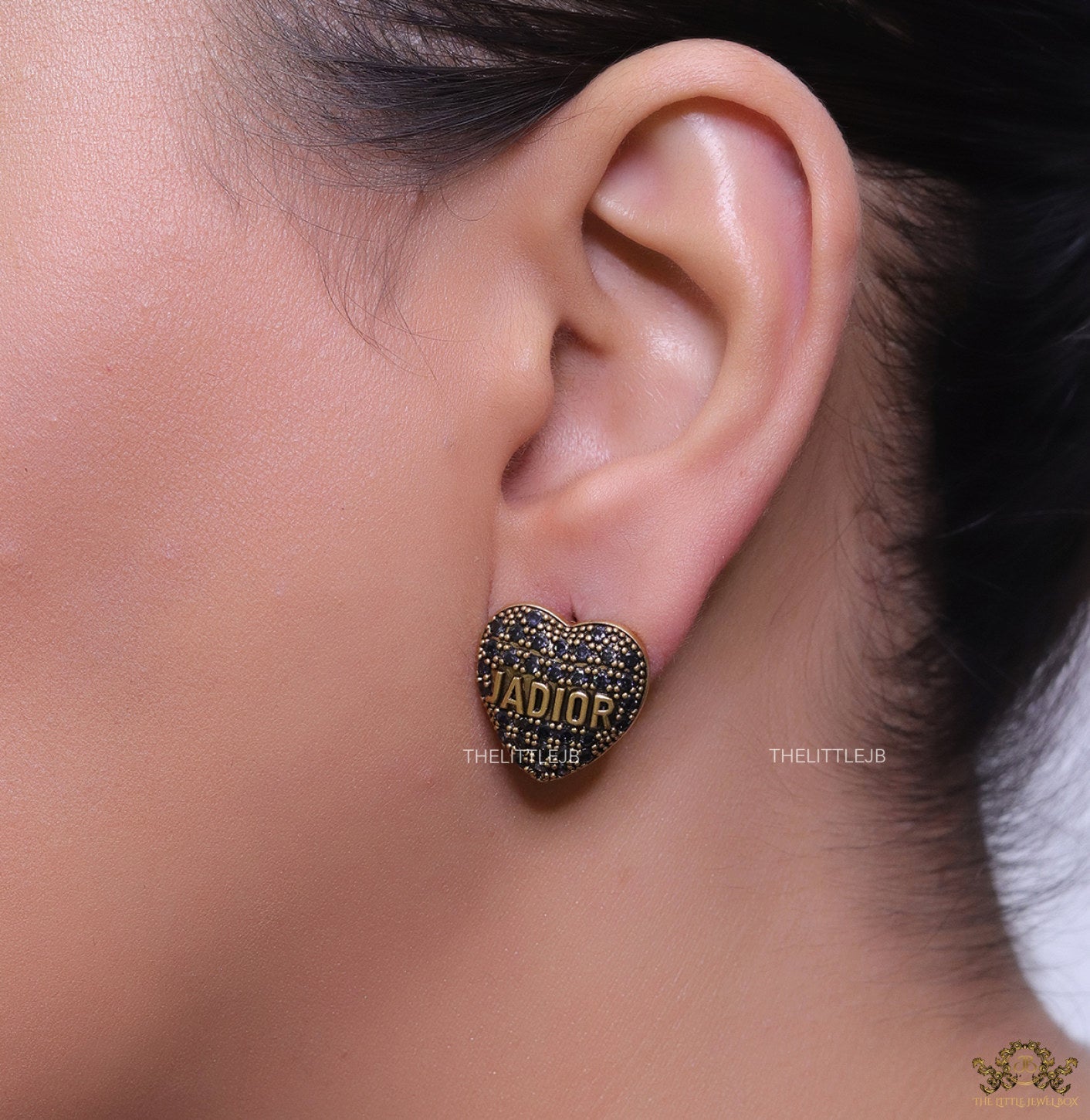 Heart shaped alphabet stud earrings in golden and black finish