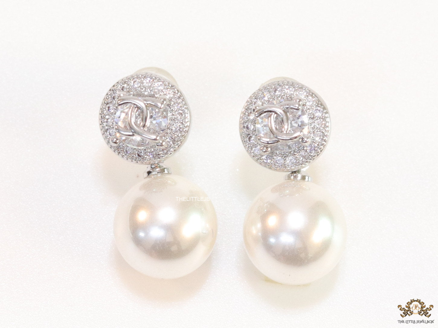 Platinum plated round cz earrings with pearl drop