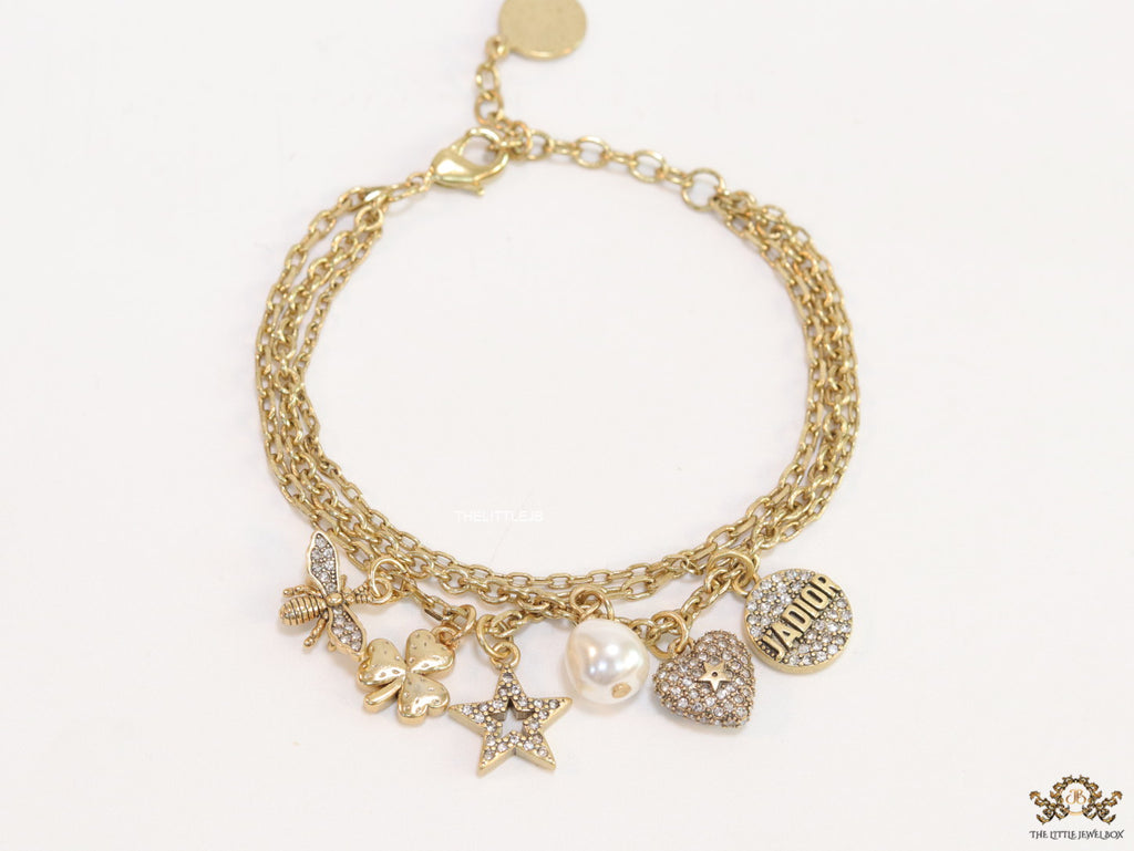 Multilayered gold plated chain bracelet with various cz charms