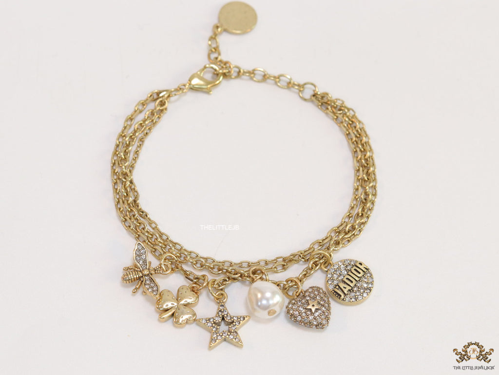 Multilayered gold plated chain bracelet with various cz charms