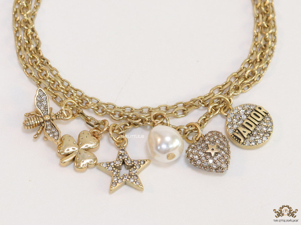 Multilayered gold plated chain bracelet with various cz charms