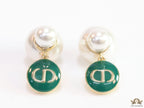 Golden pearl bomber earrings with green alphabet drop