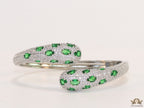 Platinum plated open cz bracelet with emerald green stones