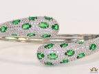 Platinum plated open cz bracelet with emerald green stones