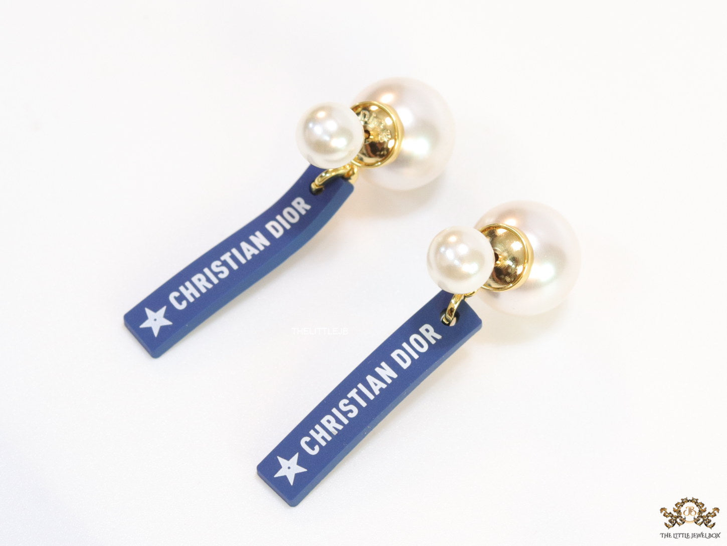 Blue silicon lapel drops with branding on pearl bomber studs