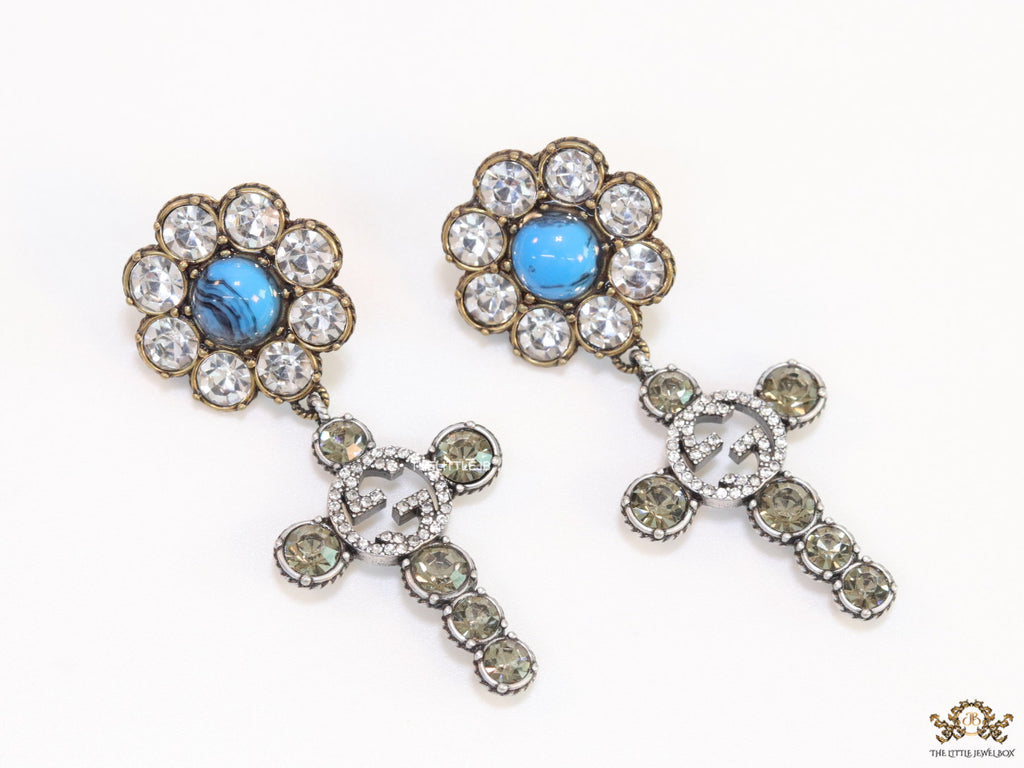 Floral cz and alphabet dangles with blue stone centre