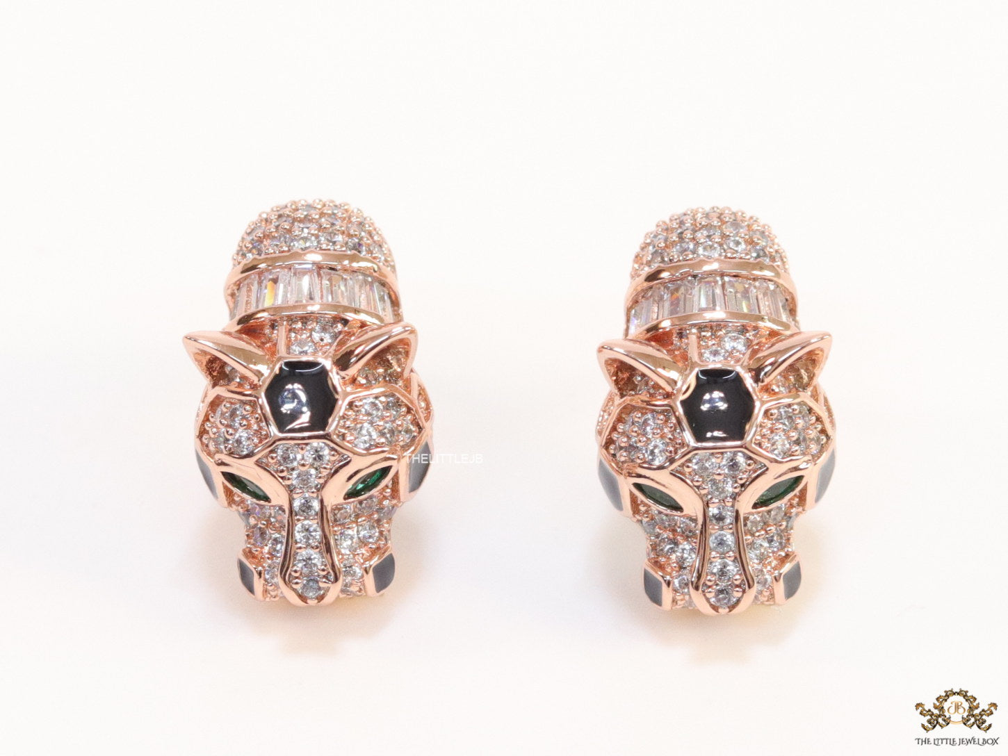 Asymmetrical cz and baguette panther studs in rose gold finish