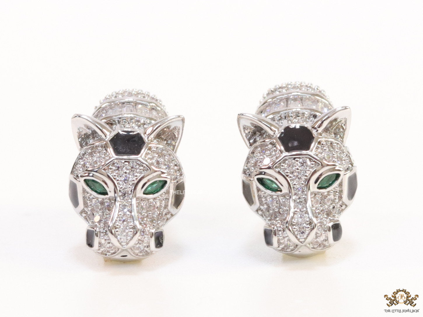 Asymmetrical cz and baguette panther studs in platinum finish