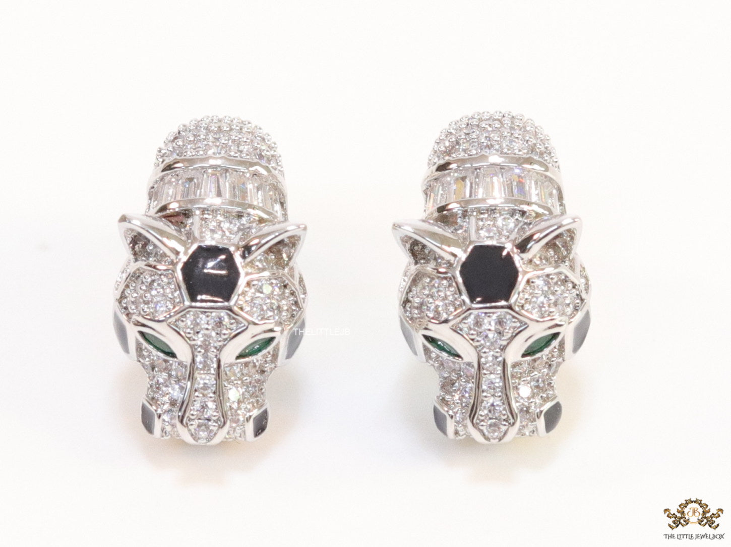 Asymmetrical cz and baguette panther studs in platinum finish