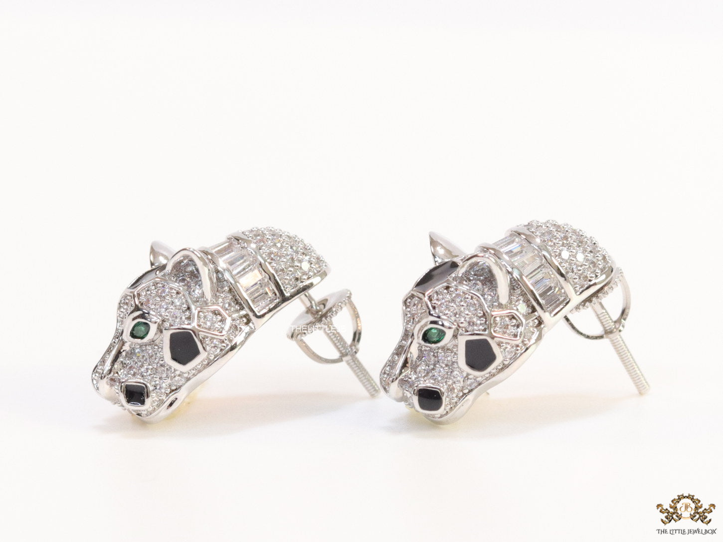 Asymmetrical cz and baguette panther studs in platinum finish