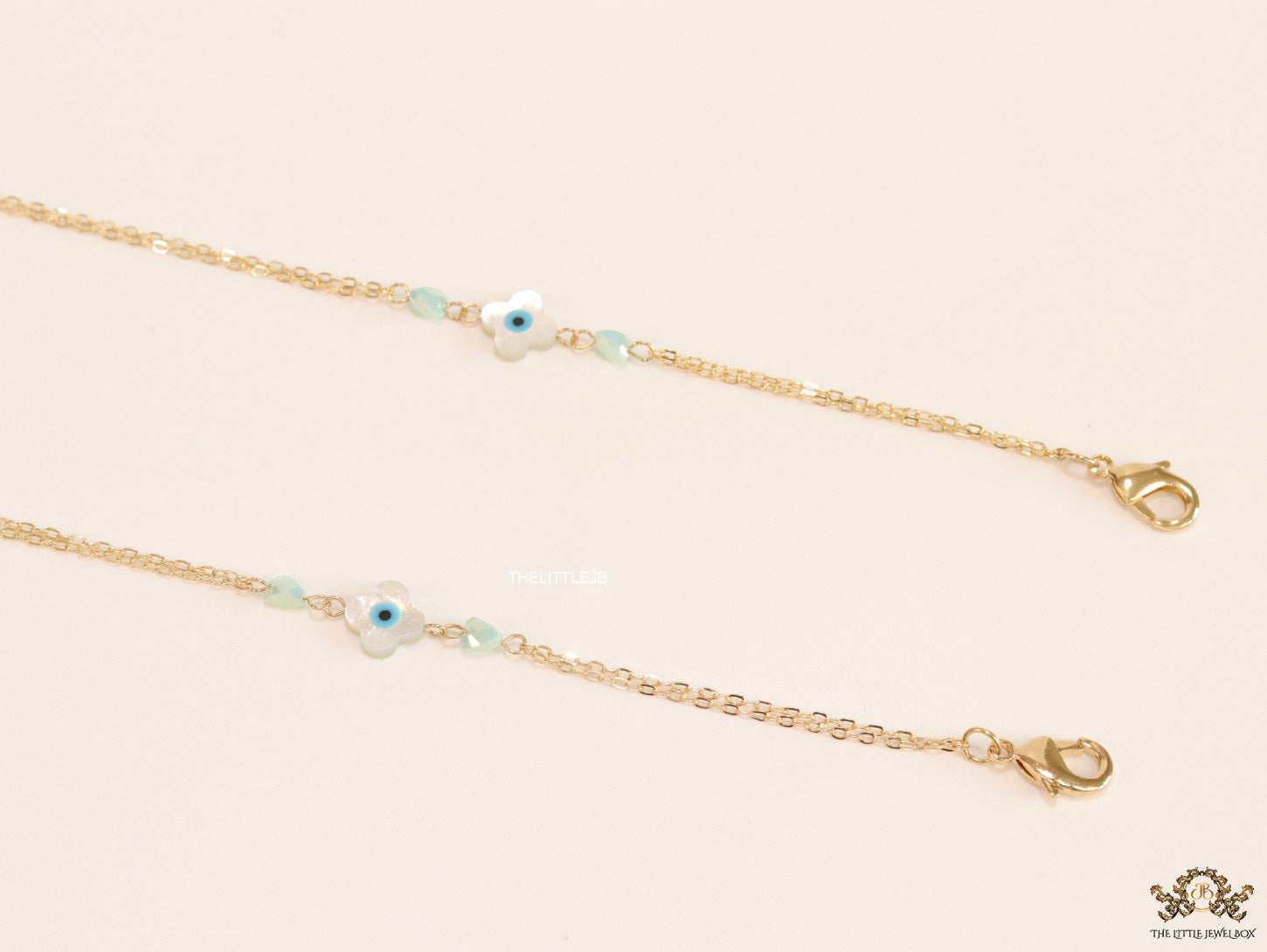 Golden mask chains with MOP evil eye clovers