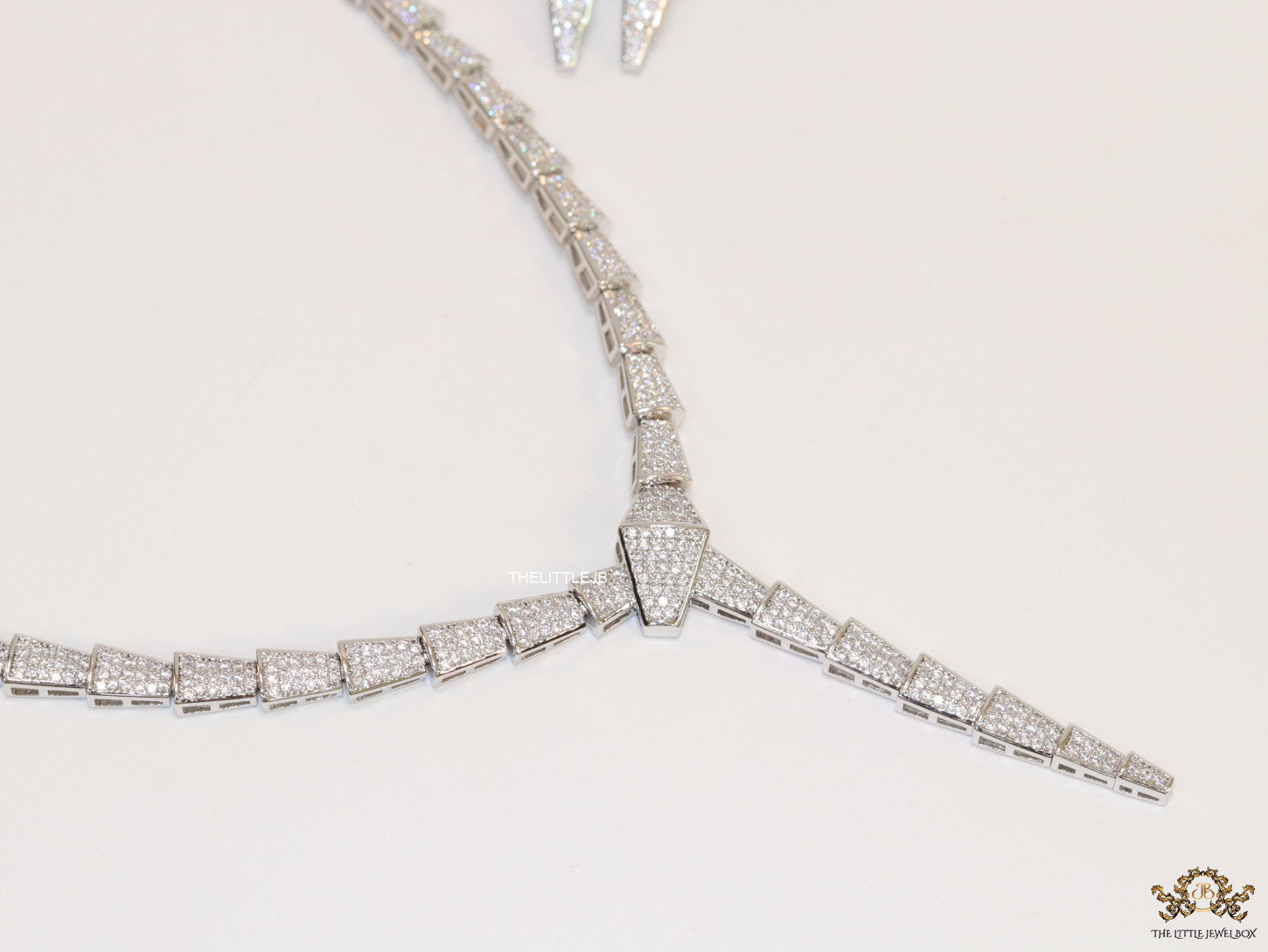 Platinum plated serpentine look knot necklace in cz