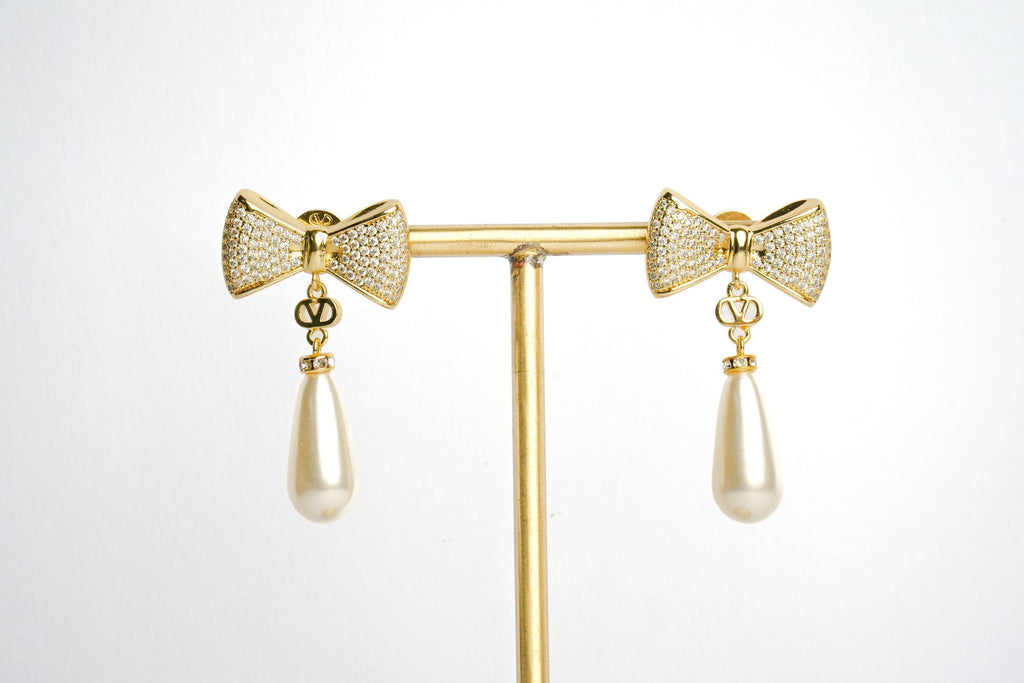 Alphabet V Bow Motif Long Pearl Dangler with CZ in Gold | Elegant Drop Earrings