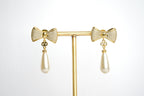 Alphabet V Bow Motif Long Pearl Dangler with CZ in Gold | Elegant Drop Earrings