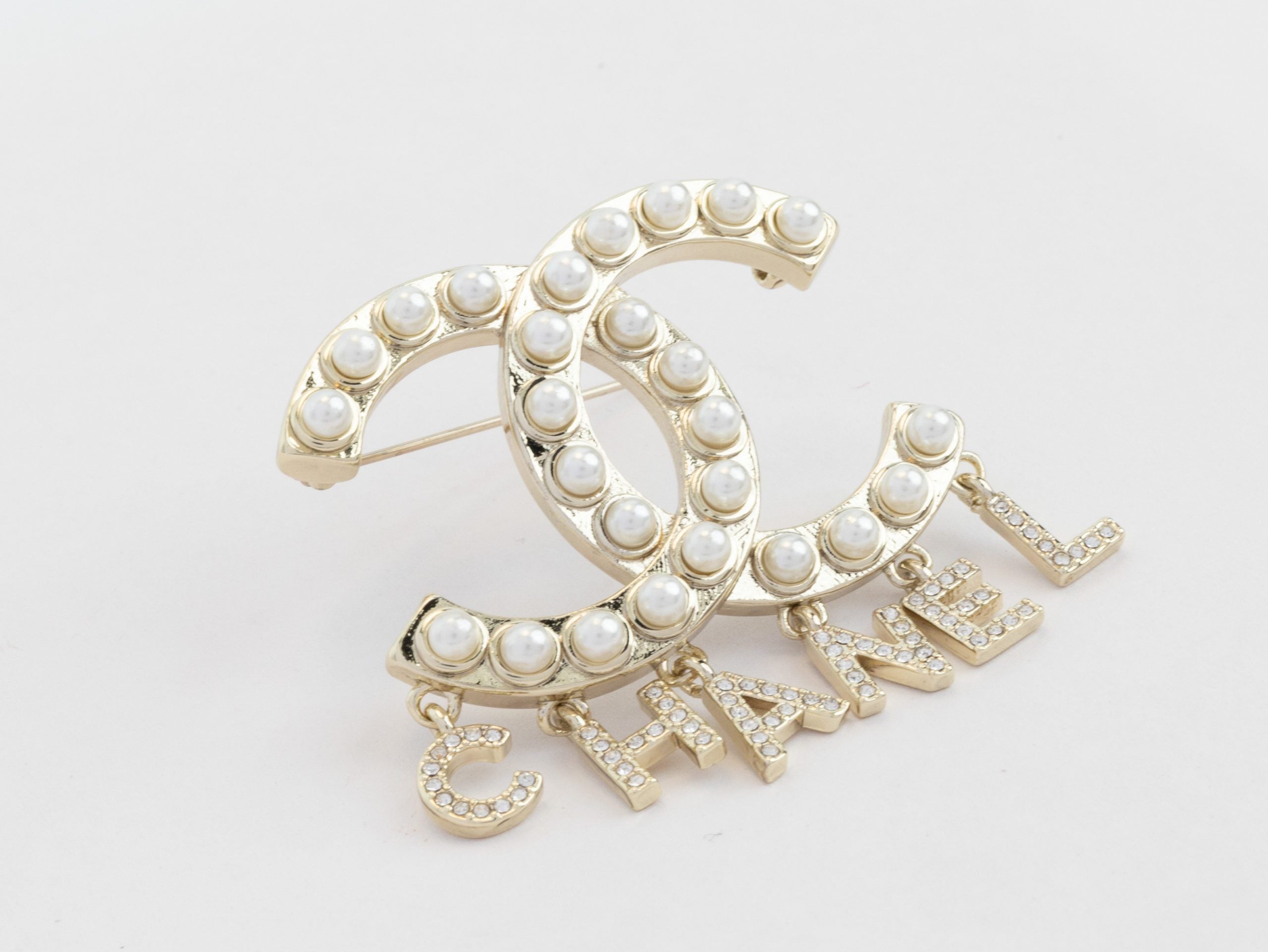 Platinum Double C pearl brooch with charms