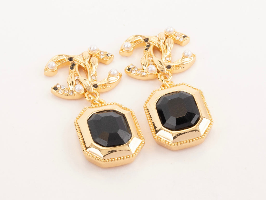 Gold Double C earrings with black enamel hanging