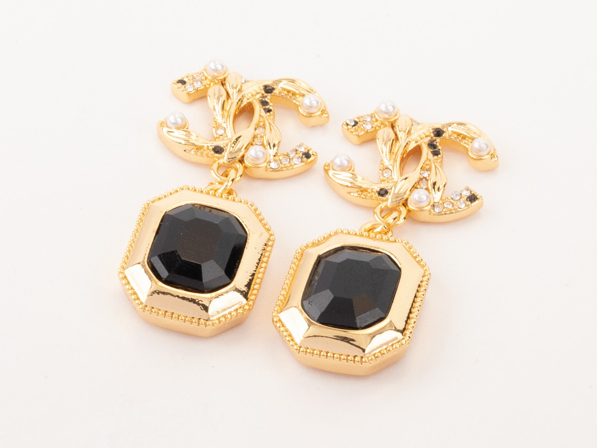 Gold Double C earrings with black enamel hanging