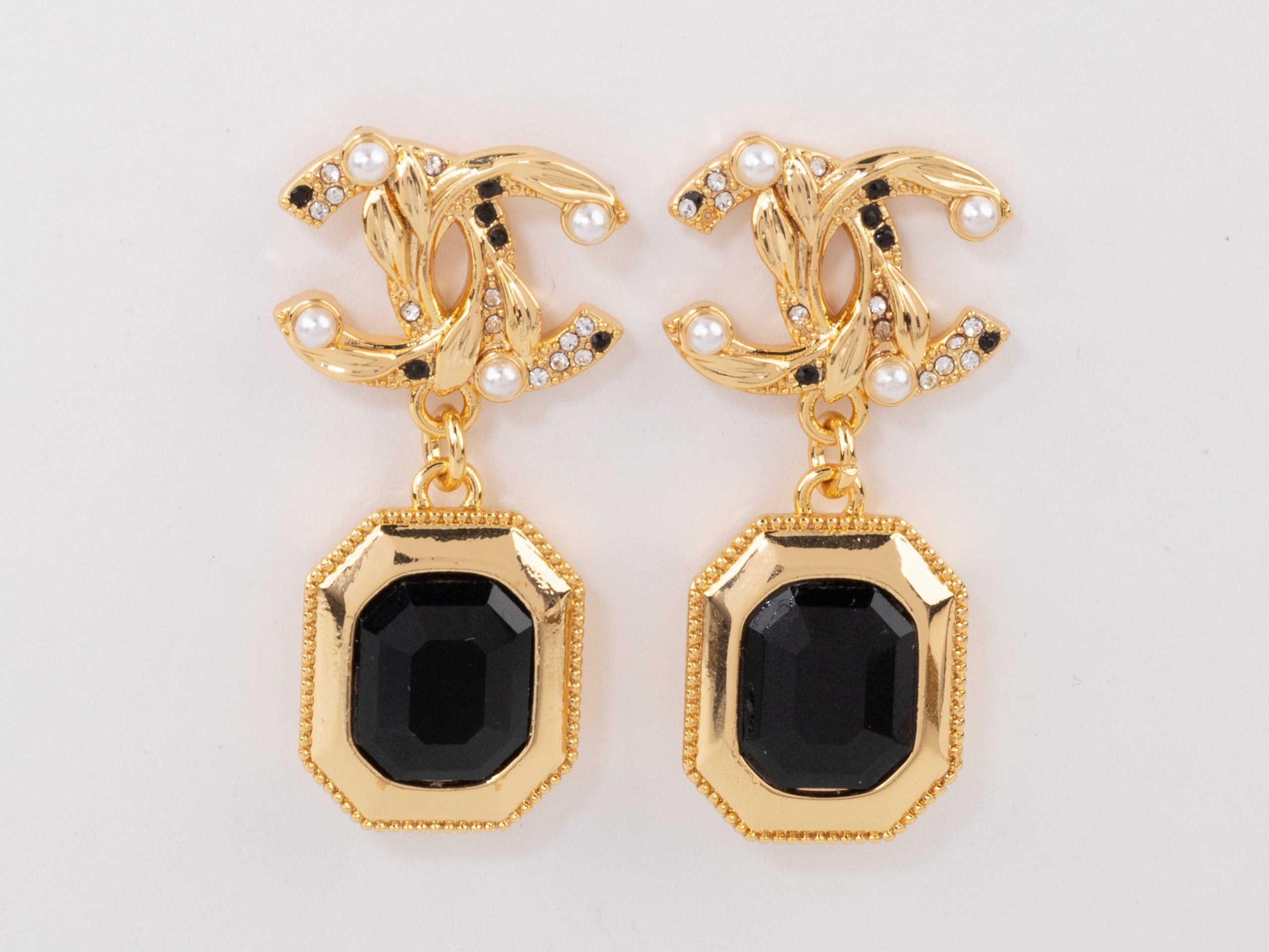 Gold Double C earrings with black enamel hanging