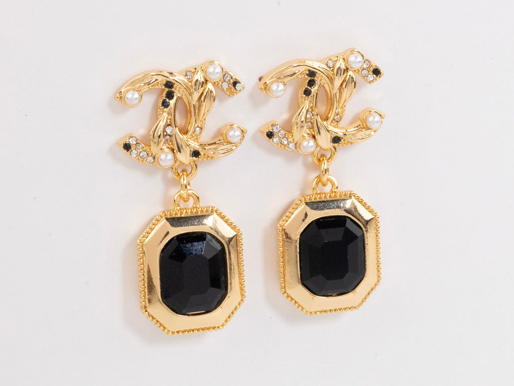 Gold Double C earrings with black enamel hanging