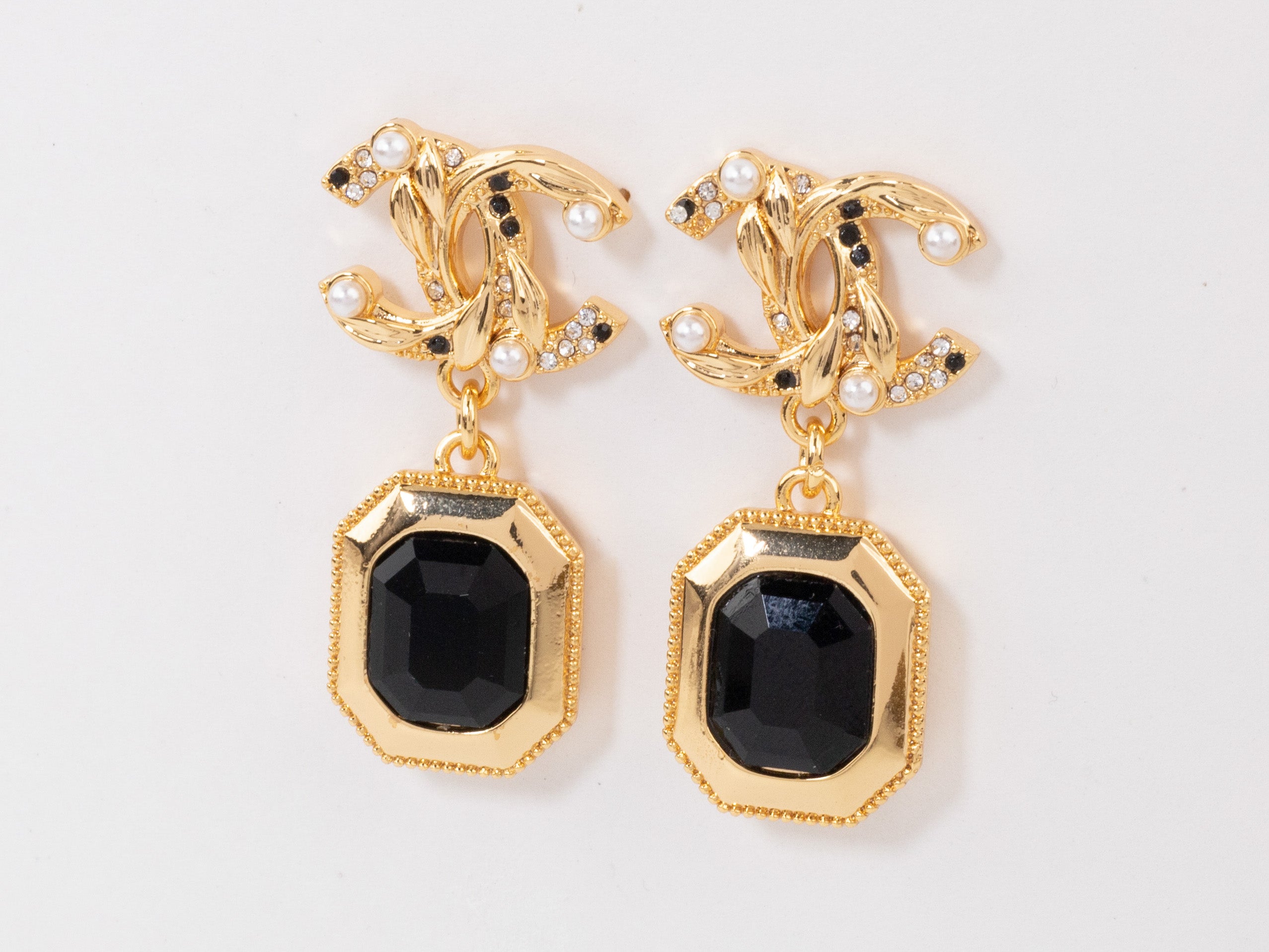 Gold Double C earrings with black enamel hanging