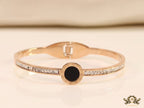 Rose gold plated cz bracelet with roman numerals inscribed on black centre motif