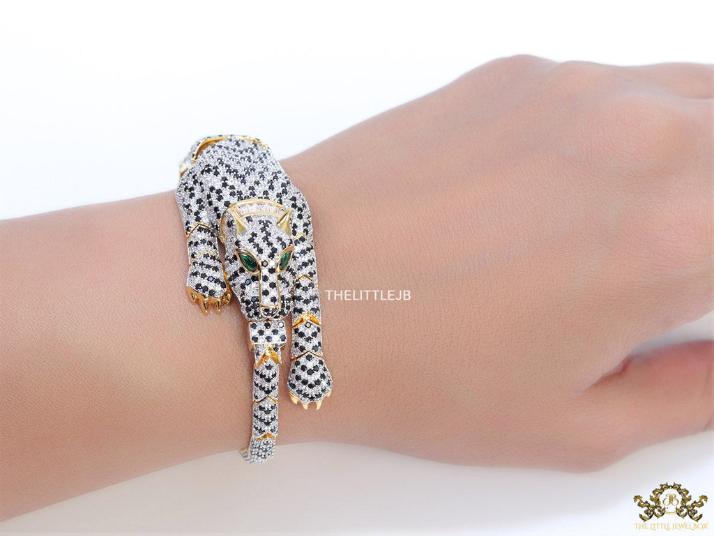 Cubic zirconia stone studded panther motif with emerald green colour stone details gold plated bracelet