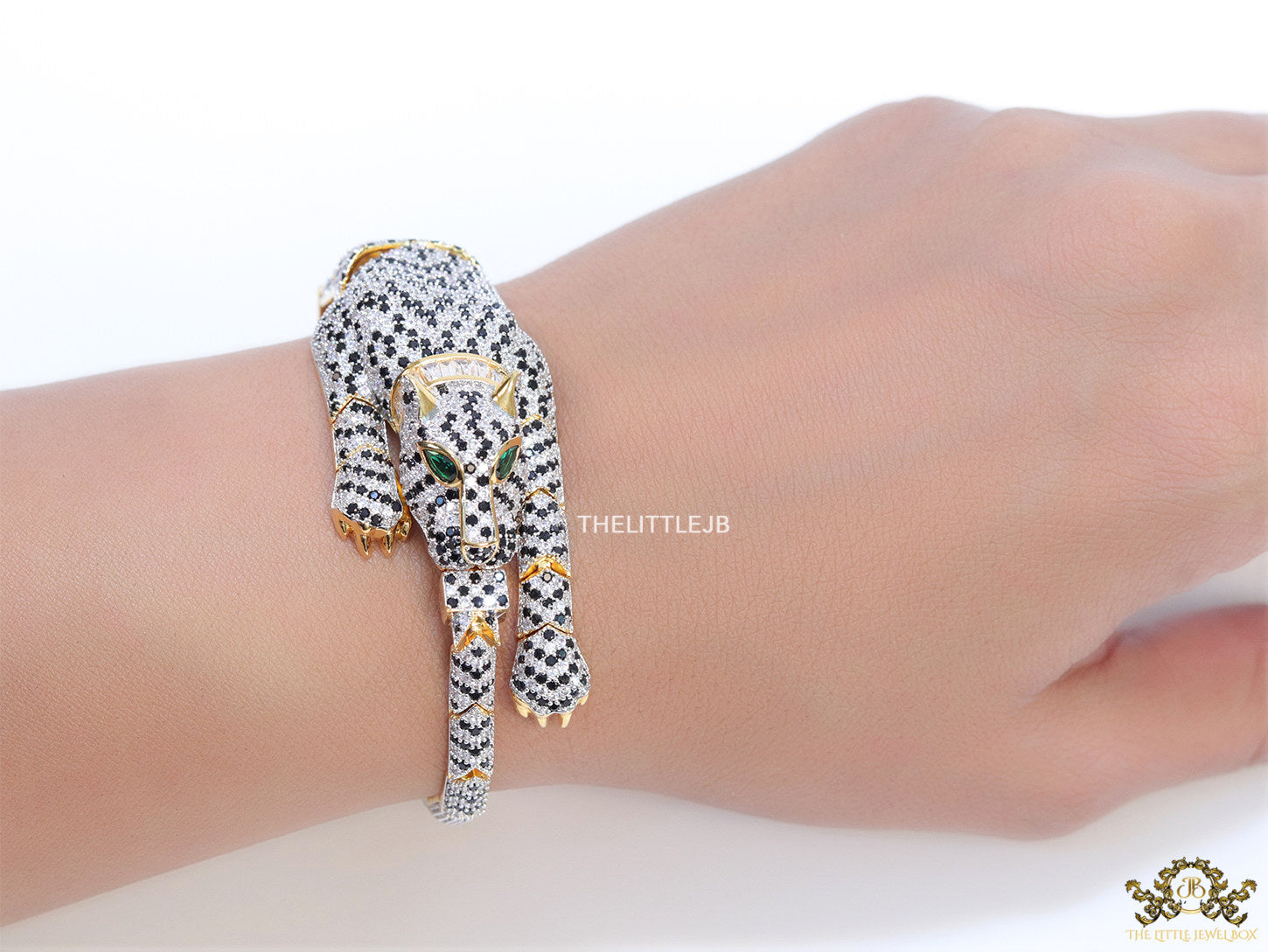 Cubic zirconia stone studded panther motif with emerald green colour stone details gold plated bracelet