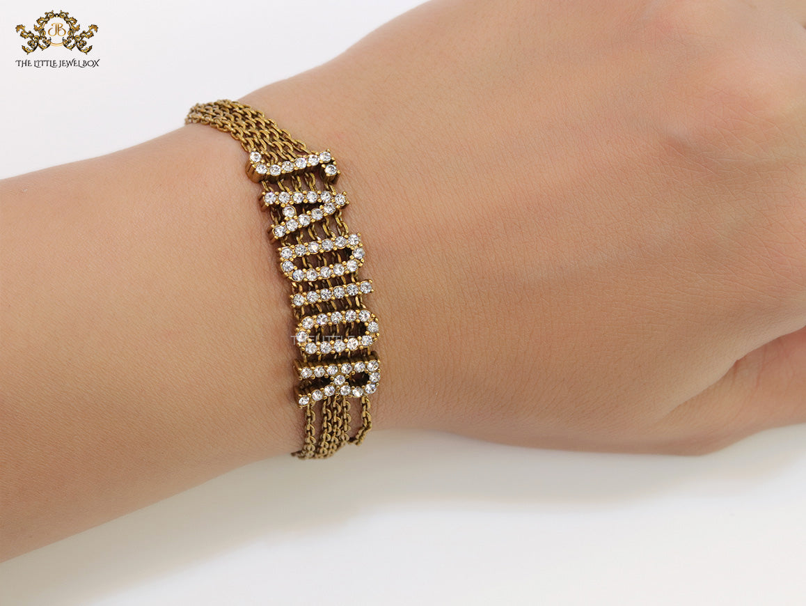Multichain bracelet with cz alphabets in antique gold finish